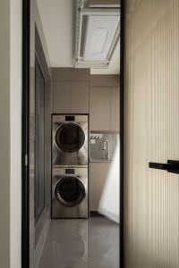 Modern laundry room with metallic washing machine and dryer