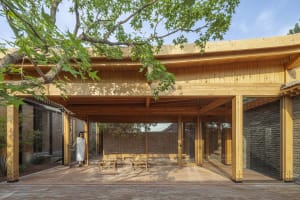 Modern wooden architecture with glass and brick exterior.