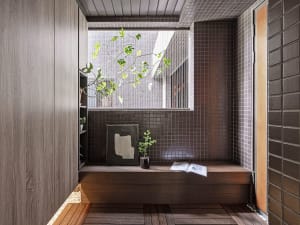 Industrial indoor space featuring a relaxation nook, with a wooden bench, tiled walls, and a potted plant, for a serene atmos