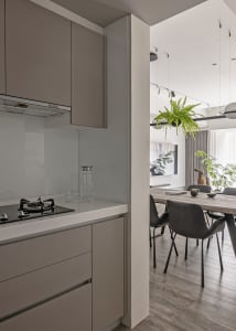 Kitchen with minimalist design, neutral tones, and glass backsplash.