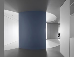 Modern, minimalist interior featuring a concrete column.