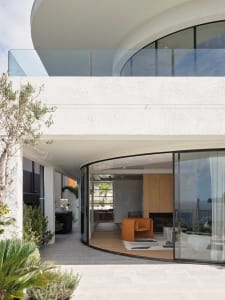 Modern residential interior featuring glass and concrete materials