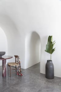 A minimalist living room featuring marble floors and a modern design.