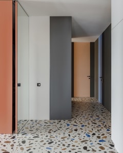 A modern interior design featuring a corridor with a terrazzo floor.