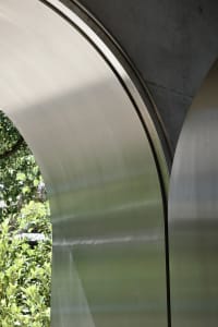 Steel arches against a natural backdrop