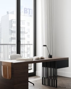Modern minimalist home office featuring a wooden desk, leather chair, and metal lamp with an open book on the desk.