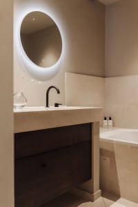 Modern bathroom featuring a marble countertop and sink with minimalist design elements.