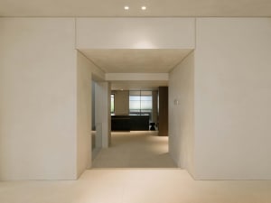 A minimalist interior space featuring concrete walls and flooring.