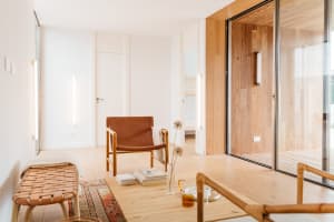 A minimalist living room featuring wood elements and furniture.