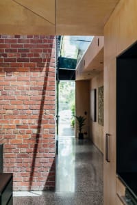 A modern interior with a visible brick wall and wooden structure.