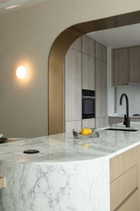 Modern kitchen with marble countertops and wooden cabinets