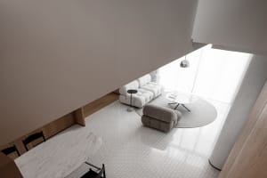 A modern living room featuring a marble table and minimalist furniture