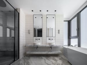 Modern bathroom with marble walls and white tiles, featuring two sinks and mirrors.