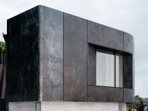 A modern building exterior made of metal material with a clean, sleek design.