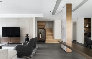 Modern living room featuring concrete and wood materials, with minimalistic decor and stylish furniture.