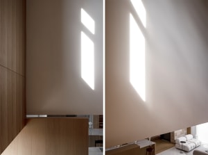 Interior design showcasing natural light through geometric window placements, contributing to a minimalist aesthetic.