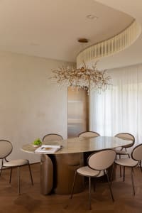 Modern dining room with a marble and metal table and chairs.
