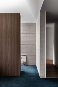 Contemporary space featuring industrial, minimalist aesthetic with concrete walls and wooden elements