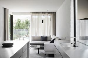 Modern living room with concrete flooring and minimalist design.