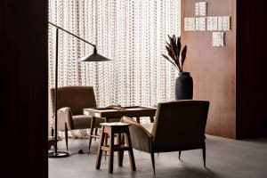 Modern living room with fabric furniture, wooden accents, and ceramic plant pot
