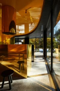 Modern interior space featuring a minimalist metal counter with a curved design.