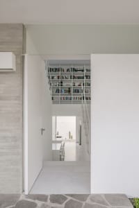 A modern interior space featuring concrete shelving filled with books.