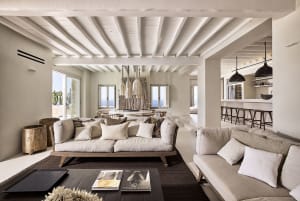 A spacious, modern living room with neutral-toned furniture and decor.
