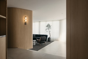 A modern living room with wooden walls and furniture.