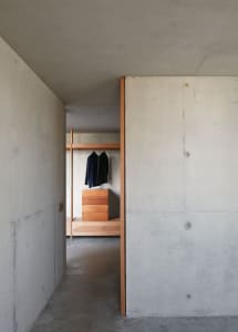Concrete and wooden closet view showcasing minimalist design.