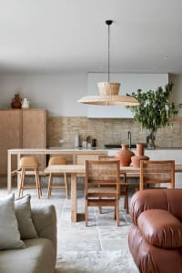 Modern minimalist residential kitchen with wooden furniture and exposed brick walls