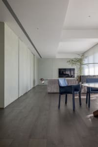 Contemporary living room featuring wood flooring and minimalist furniture.