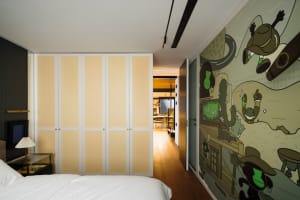 A modern residential interior showcasing a stylish and contemporary design with vibrant colors and creative wall art.
