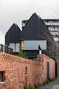 Modern architectural design featuring metal cladding and brick exterior