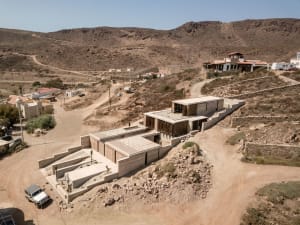 Modern residential architecture featuring contemporary design in a desert setting.