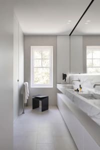 Modern bathroom featuring marble countertop and concrete floor