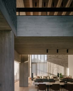 Interior of a modern living room featuring concrete and wooden elements.