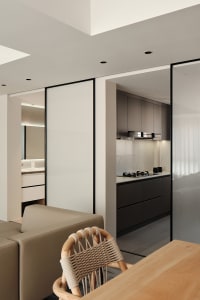 Modern minimalist kitchen featuring dark wood furniture and white marble countertops.