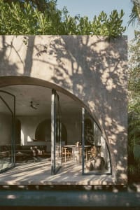 Modern living space with concrete walls and large windows.
