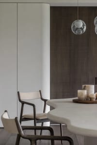 Modern dining room featuring marble and concrete elements.