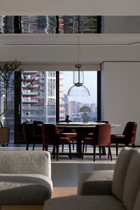 A modern living room with concrete and glass materials.