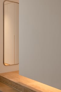 Modern minimalist interior space featuring glass materials and clean lines.