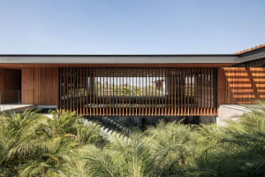 A modern architectural exterior featuring a wooden facade with vertical slats.