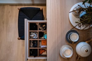 A neatly organized wardrobe storage unit showcasing modern design with wood material.