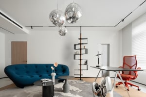 Modern living room featuring sleek metal furniture and glass accents