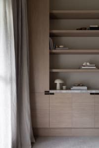 A modern bookshelf with wooden cabinets and wooden shelves.