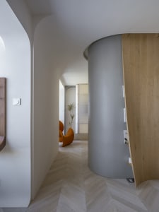 Modern corridor featuring wooden tiles and concrete columns