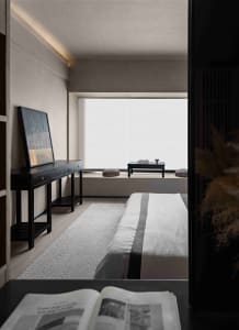 Modern minimalist bedroom with textured materials and a serene ambiance.