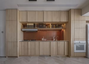 Modern minimalist kitchen featuring wood cabinets and a sleek design.