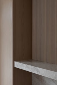 A minimalist interior design featuring marble and concrete materials.