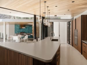Modern kitchen with concrete flooring, countertops, and island.